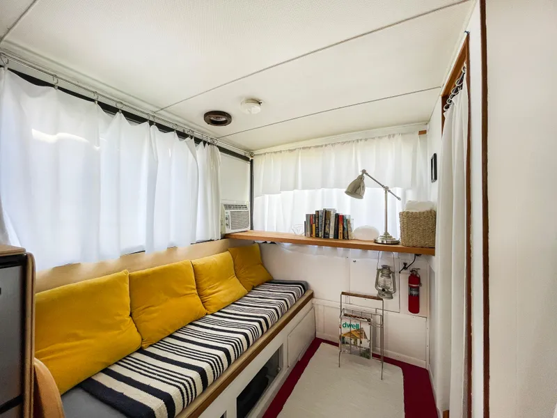 Slide: The Image of Cozy interior of 1970 Tollycraft Tollyhome 36 with yellow cushions and striped bench. - 41