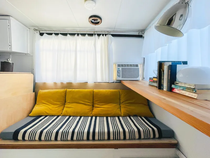 Slide: The Image of Cozy interior of 1970 Tollycraft Tollyhome 36 with yellow cushions and striped blanket. - 43