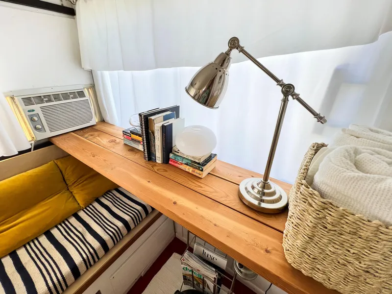 Slide: The Image of 1970 Tollycraft Tollyhome 36 interior with wooden shelf, books, lamp, and cozy seating. - 47