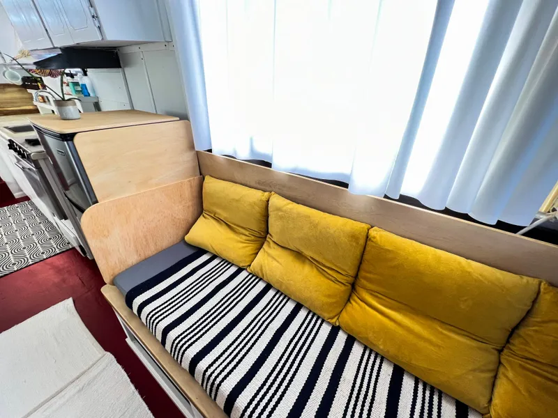 Slide: The Image of 1970 Tollycraft Tollyhome 36 interior with yellow cushions and striped sofa. - 48