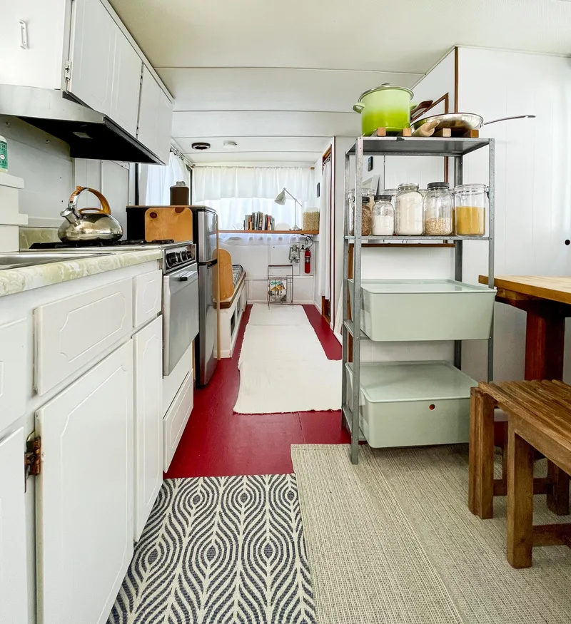 Slide: The Image of 1970 Tollycraft Tollyhome 36 interior with kitchen, shelves, and dining area. - 6