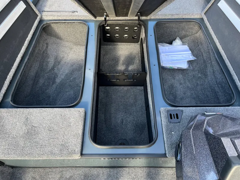 Slide: The Image of 2024 Ranger RT188 boat storage compartments with carpeted interior. - 5