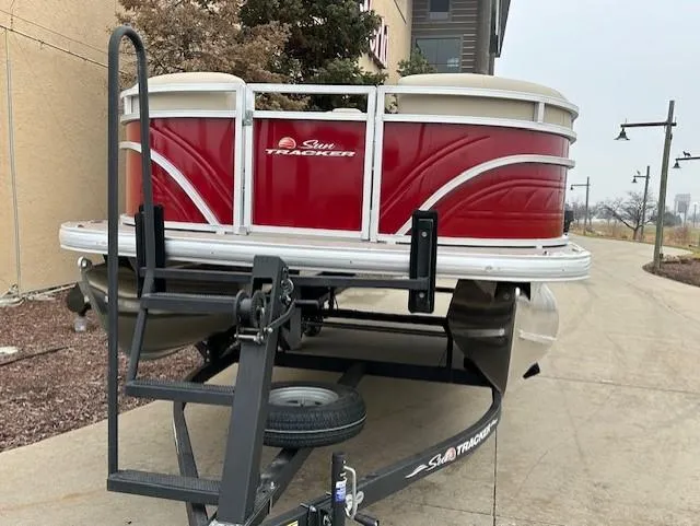 Slide: The Image of 2024 Sun Tracker Party Barge 20 DLX pontoon boat on a trailer. - 2