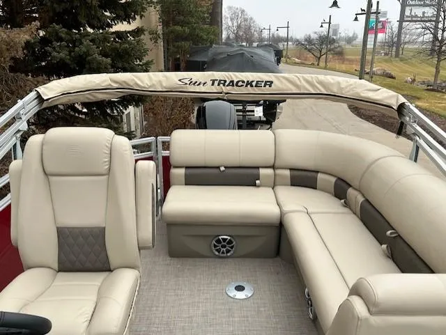 Slide: The Image of 2024 Sun Tracker Party Barge 20 DLX interior with beige seating and ample space. - 3