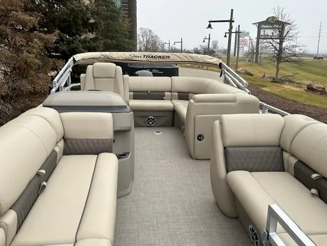 Slide: The Image of 2024 Sun Tracker Party Barge 20 DLX pontoon boat with beige seating and spacious layout. - 4