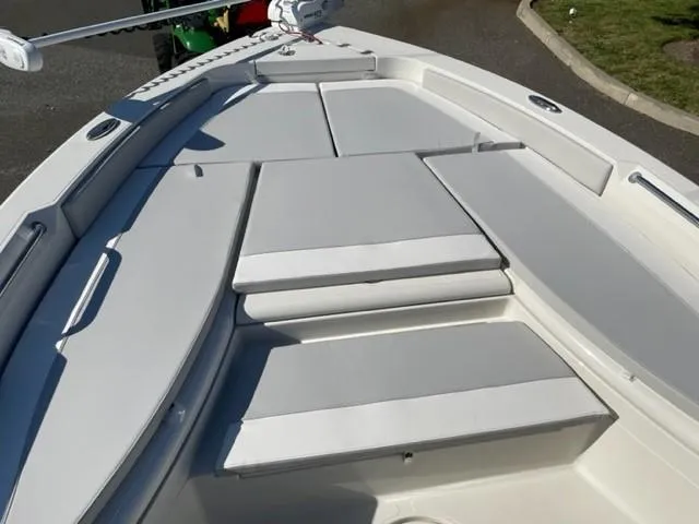 Slide: The Image of 2024 Ranger 2660 Bay boat with cushioned seating area. - 6