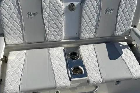 Slide: The Image of 2024 Ranger 2660 Bay boat with white quilted seating and built-in cup holders. - 9