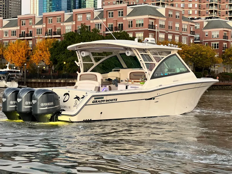 Slide: The Image of 2014 Grady-White Freedom 375 boat with triple Yamaha engines on urban waterfront. - 0