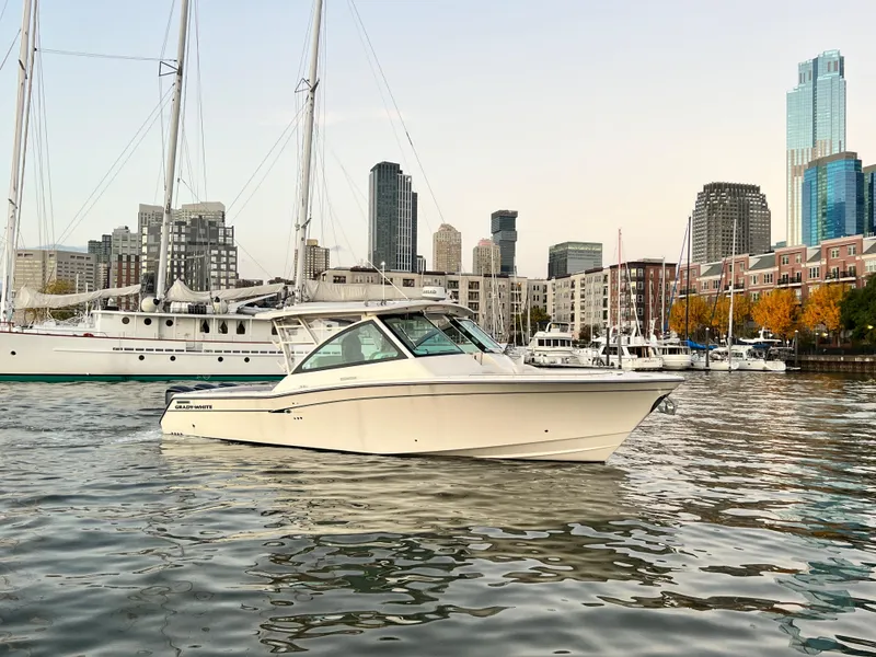 Slide: The Image of 2014 Grady-White Freedom 375 boat in urban marina with city skyline. - 1