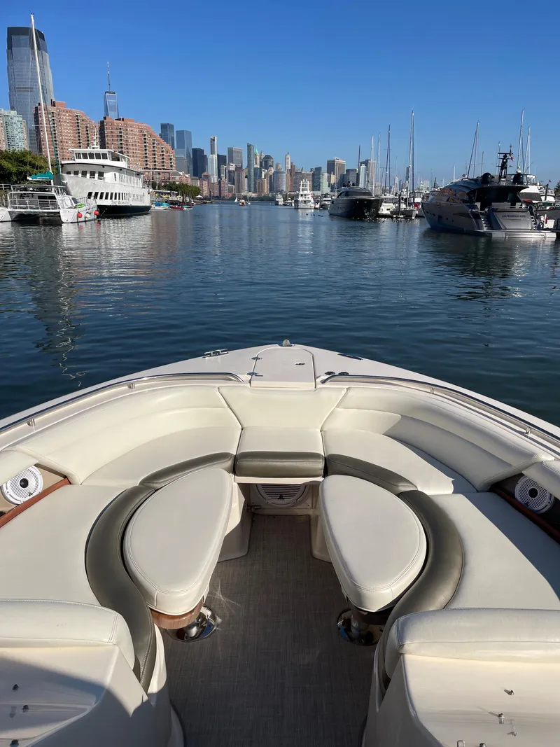 Slide: The Image of 2014 Grady-White Freedom 375 boat in a marina with city skyline. - 11