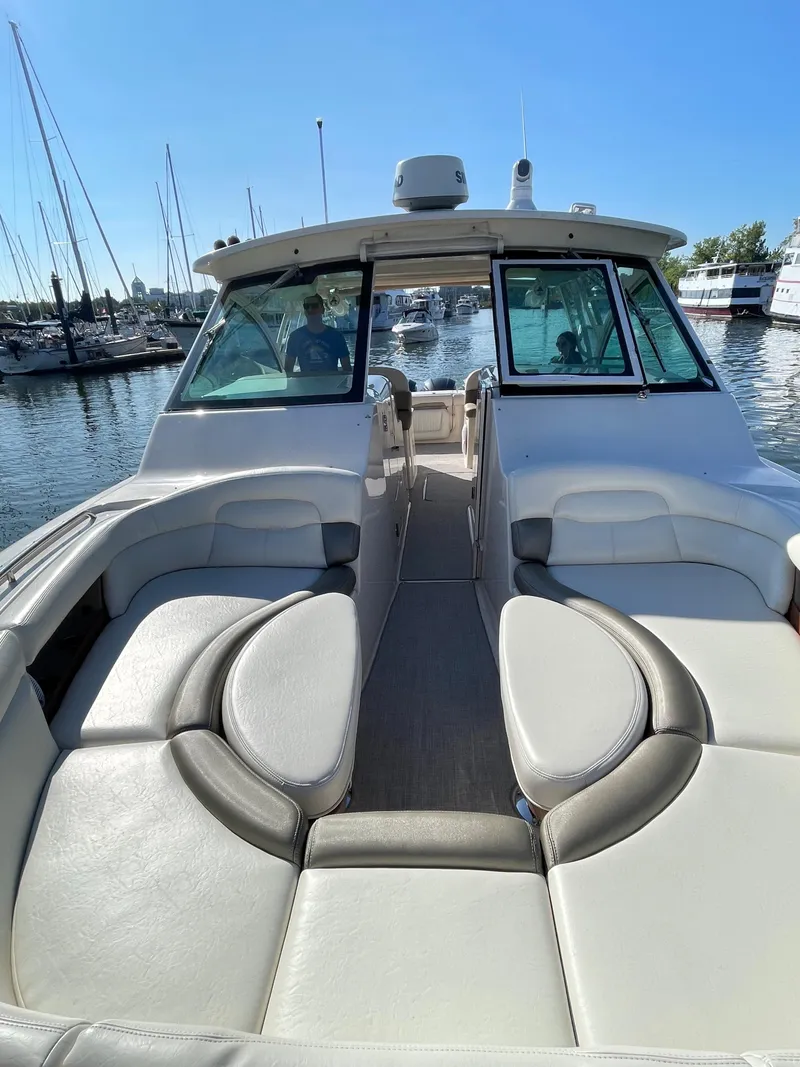 Slide: The Image of 2014 Grady-White Freedom 375 boat with spacious seating at a marina. - 12