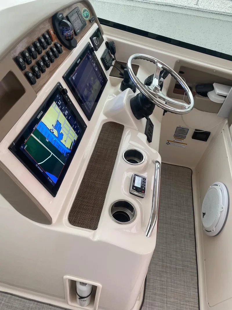 Slide: The Image of 2014 Grady-White Freedom 375 helm with dual navigation screens and steering wheel. - 5