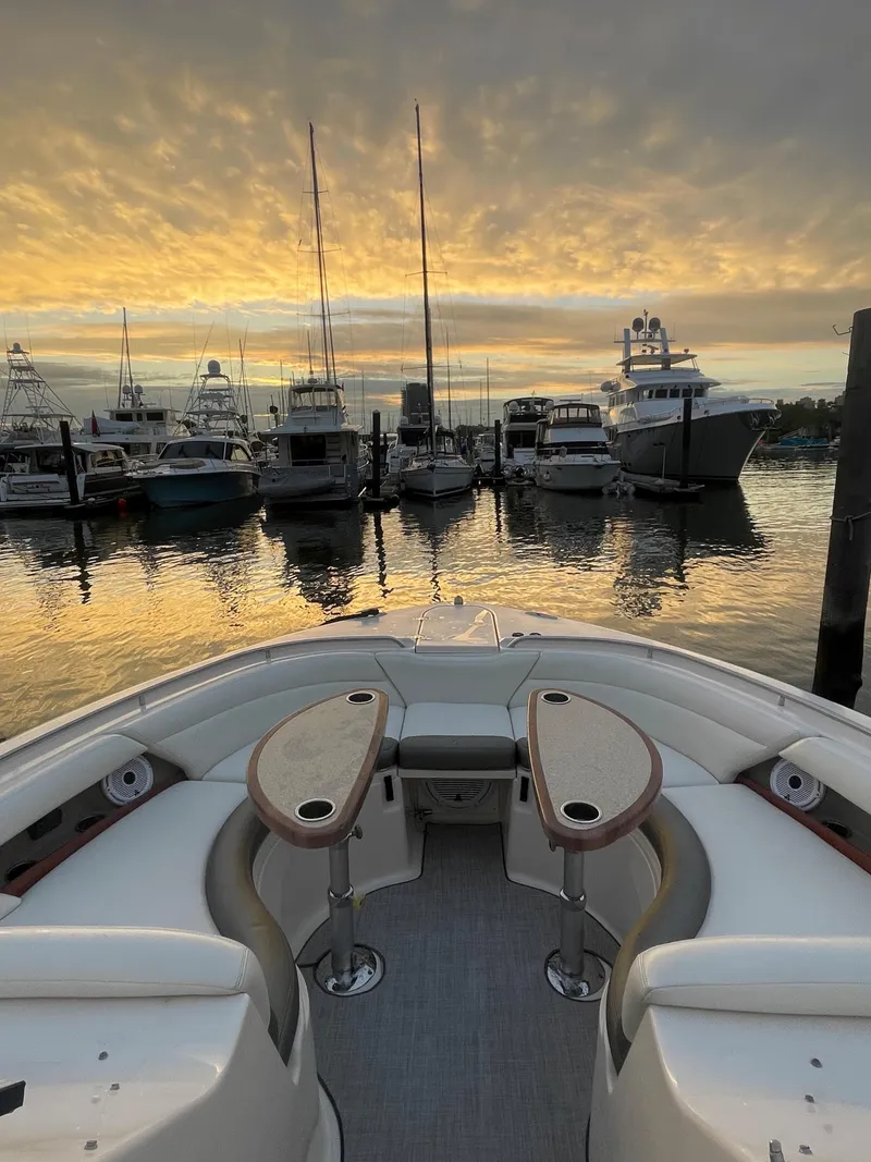 Slide: The Image of 2014 Grady-White Freedom 375 boat docked at sunset with other boats in the background. - 9
