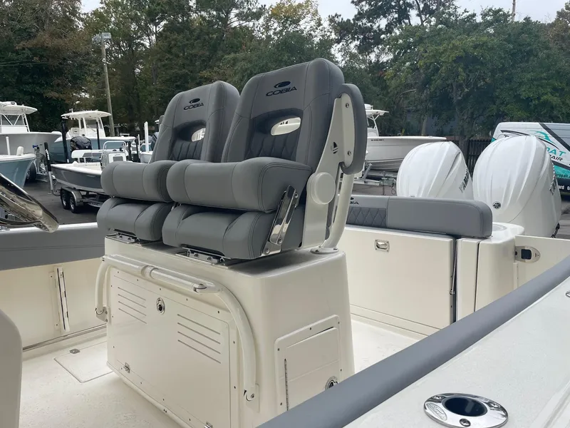 Slide: The Image of 2024 Cobia 262 Center Console boat helm with steering wheel and control panel. - 5