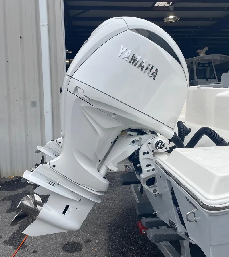 Slide: The Image of 2024 Cobia 262 Center Console boat with dual seats and storage compartments. - 6