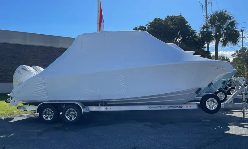 Slide: The Image of 2024 Cobia 262 Center Console boat covered on a trailer. - 8
