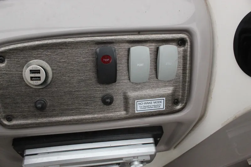 Slide: The Image of Control panel of a 2007 Yamaha Boats 230sx with USB port and switches. - 13