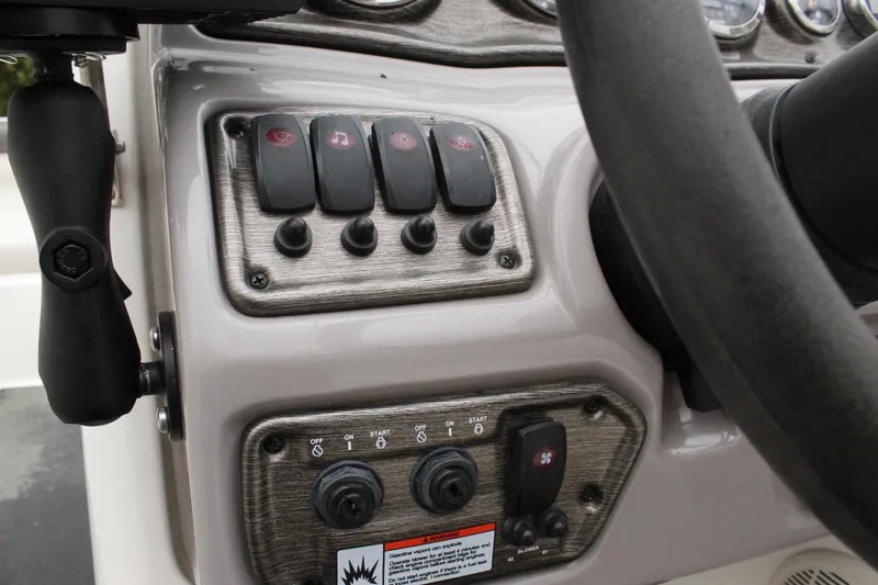 Slide: The Image of Control panel of a 2007 Yamaha Boats 230sx with switches and dials. - 14