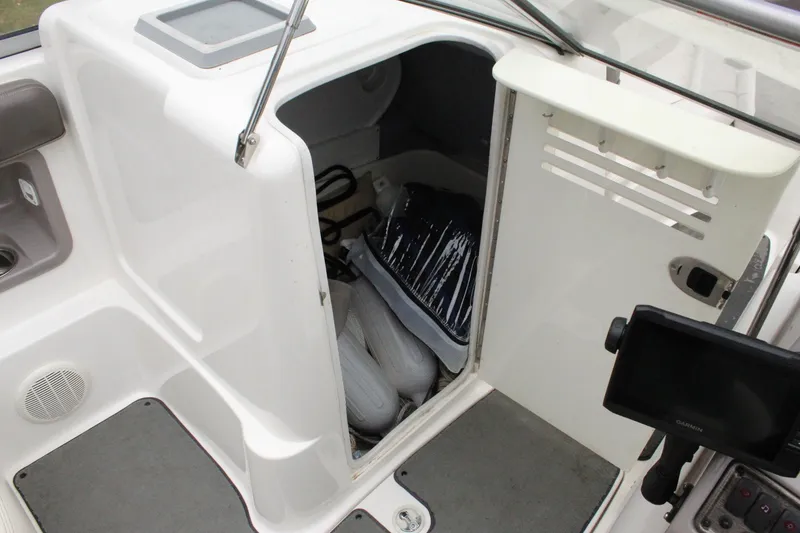 Slide: The Image of 2007 Yamaha Boats 230sx interior storage compartment with equipment. - 15