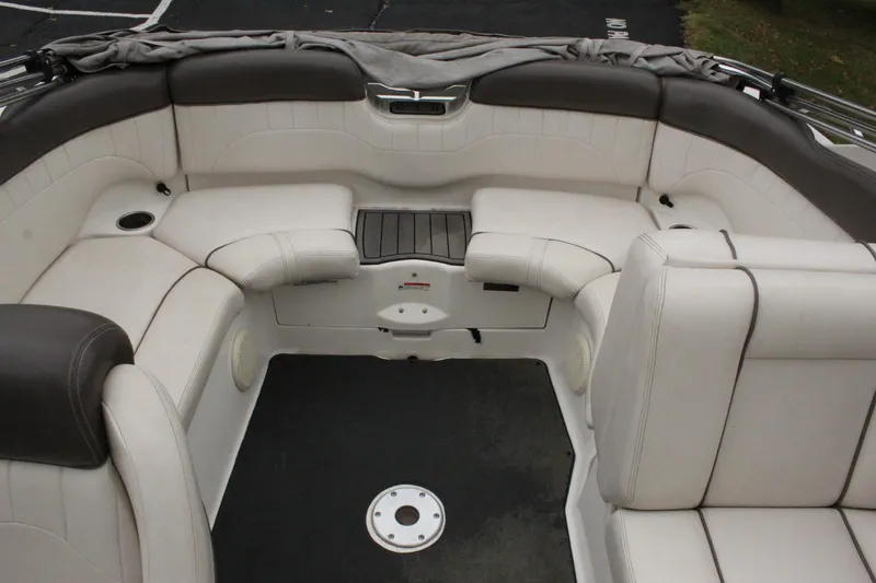 Slide: The Image of 2007 Yamaha Boats 230sx interior seating area with white and gray upholstery. - 9