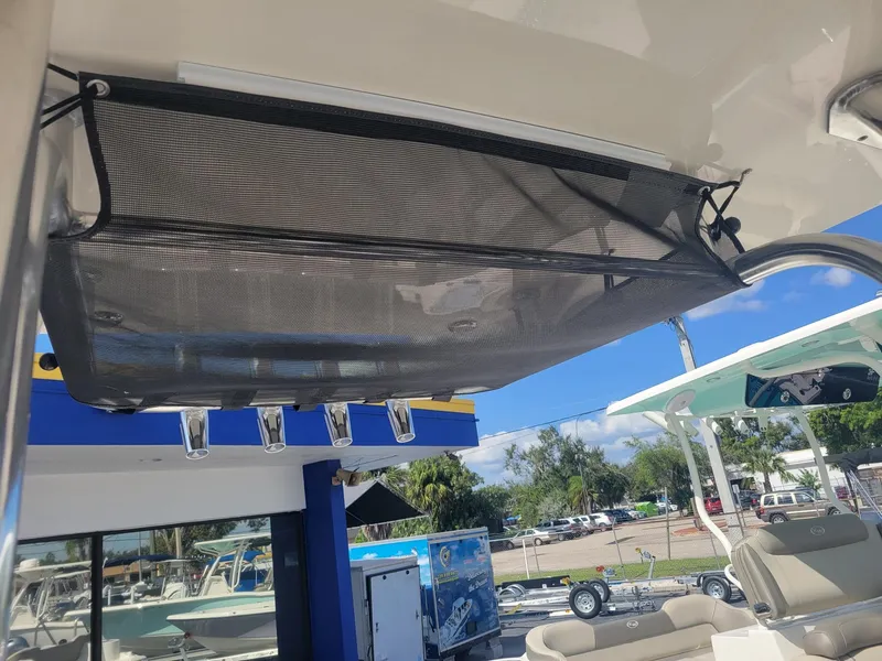 Slide: The Image of 2024 Key West 239 FS boat with overhead storage net and rod holders. - 10
