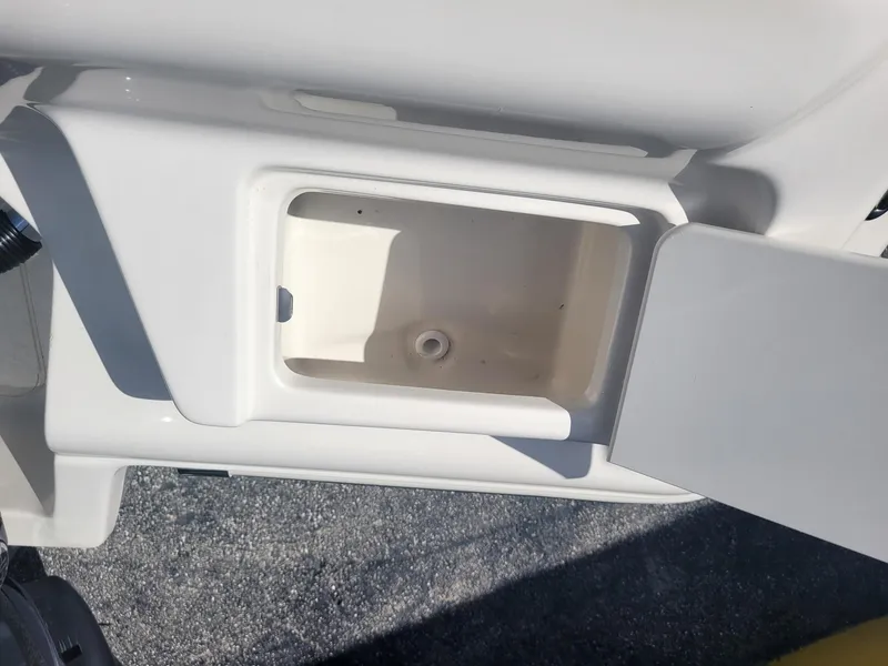 Slide: The Image of 2024 Key West 239 FS boat storage compartment with open lid. - 16