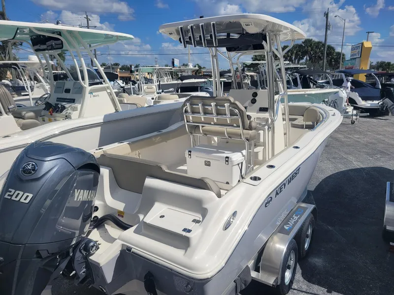 Slide: The Image of 2024 Key West 239 FS boat with Yamaha 200 engine in a marina. - 2