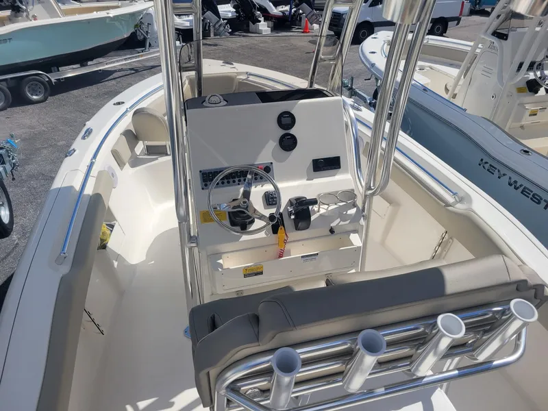 Slide: The Image of 2024 Key West 239 FS boat interior with steering console and rod holders. - 4