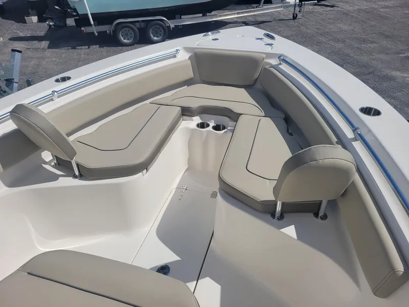 Slide: The Image of 2024 Key West 239 FS boat interior with beige seating and cup holders. - 5
