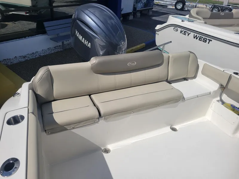 Slide: The Image of 2024 Key West 239 FS boat with Yamaha engine and beige seating. - 7