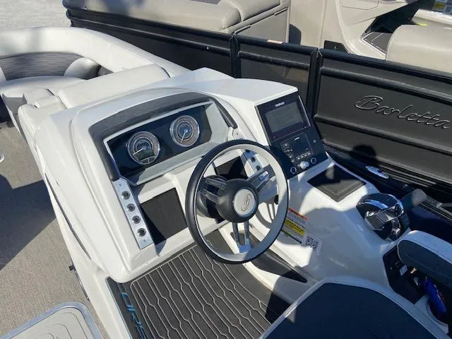 Slide: The Image of 2023 Barletta Corsa 23 UC boat cockpit with modern steering and controls. - 14