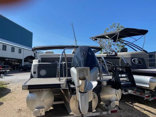 Slide: The Image of 2023 Barletta Corsa 23 UC pontoon boat on trailer, outdoor setting. - 6