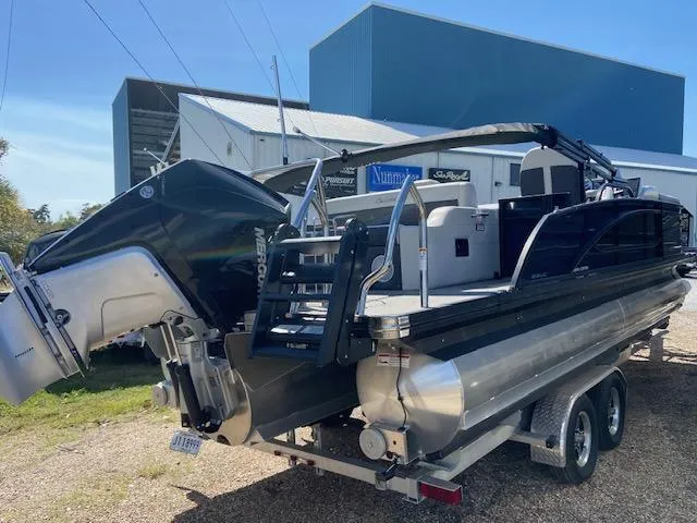 Slide: The Image of 2023 Barletta Corsa 23 UC pontoon boat with powerful outboard motor, docked outdoors. - 7