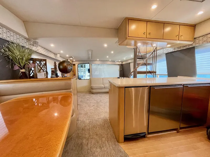 Slide: The Image of Luxurious interior of 2003 Ocean Yachts 62 Convertible with modern kitchen and dining area. - 11