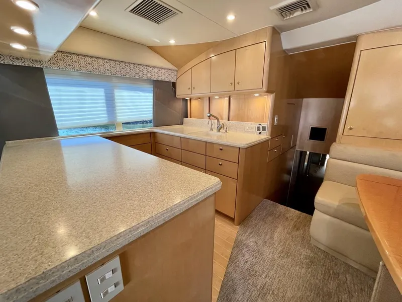 Slide: The Image of 2003 Ocean Yachts 62 Convertible kitchen with modern cabinetry and ample counter space. - 12