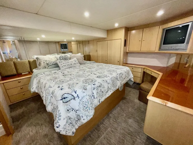 Slide: The Image of Luxurious bedroom in 2003 Ocean Yachts 62 Convertible with cozy bedding and ample storage. - 15