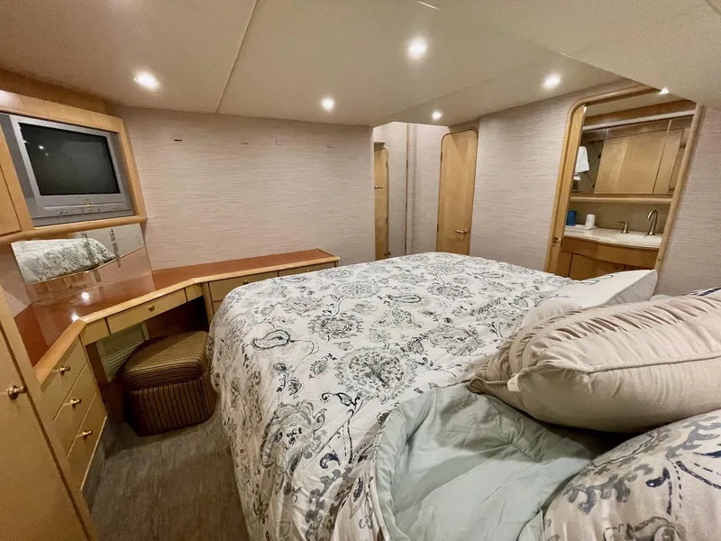 Slide: The Image of Luxurious bedroom in a 2003 Ocean Yachts 62 Convertible with elegant decor and ample lighting. - 16