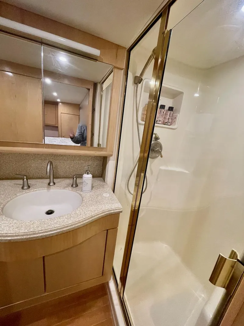 Slide: The Image of 2003 Ocean Yachts 62 Convertible bathroom with shower and vanity. - 18