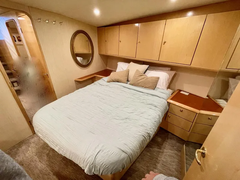 Slide: The Image of Luxurious bedroom in 2003 Ocean Yachts 62 Convertible with cozy bed and ample storage. - 20
