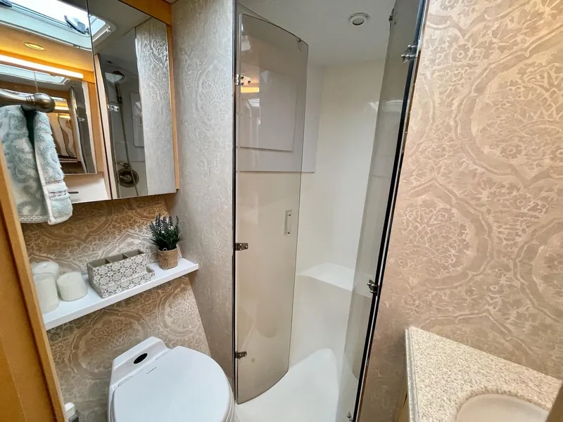 Slide: The Image of Luxurious bathroom in 2003 Ocean Yachts 62 Convertible with shower, toilet, and elegant decor. - 22