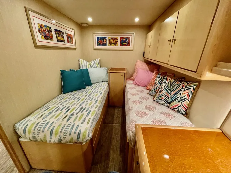 Slide: The Image of 2003 Ocean Yachts 62 Convertible cabin with twin beds and colorful pillows. - 25