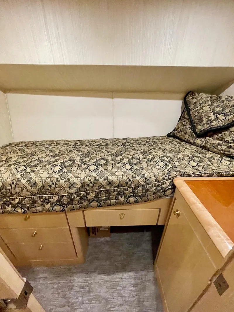 Slide: The Image of 2003 Ocean Yachts 62 Convertible cabin with single bed and storage drawers. - 27