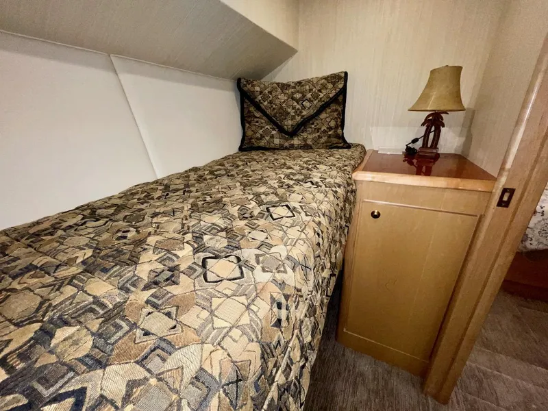 Slide: The Image of 2003 Ocean Yachts 62 Convertible cabin with single bed and nightstand. - 29