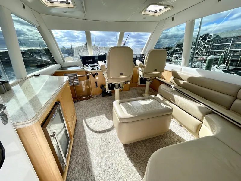 Slide: The Image of Luxurious interior of a 2003 Ocean Yachts 62 Convertible with helm chairs and panoramic windows. - 30