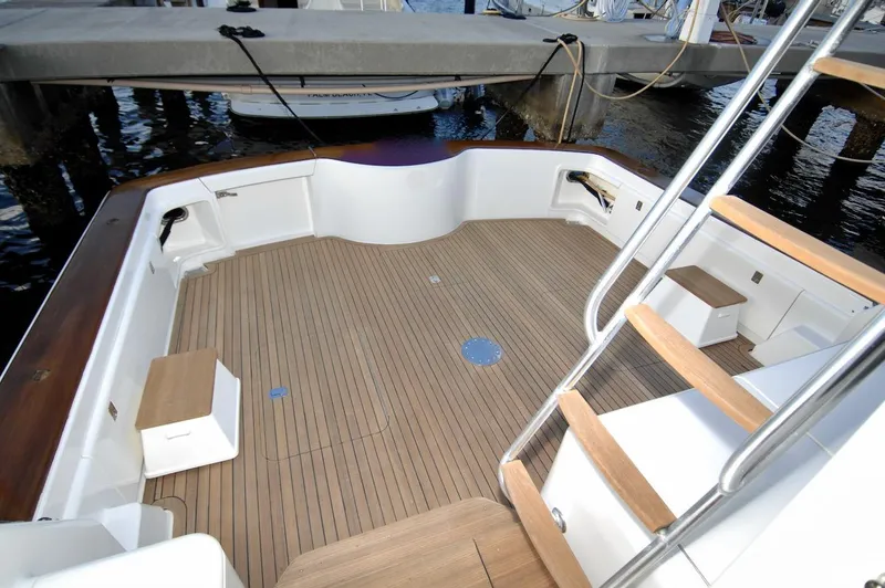 Slide: The Image of 2003 Ocean Yachts 62 Convertible boat deck with wooden flooring and docked at marina. - 38
