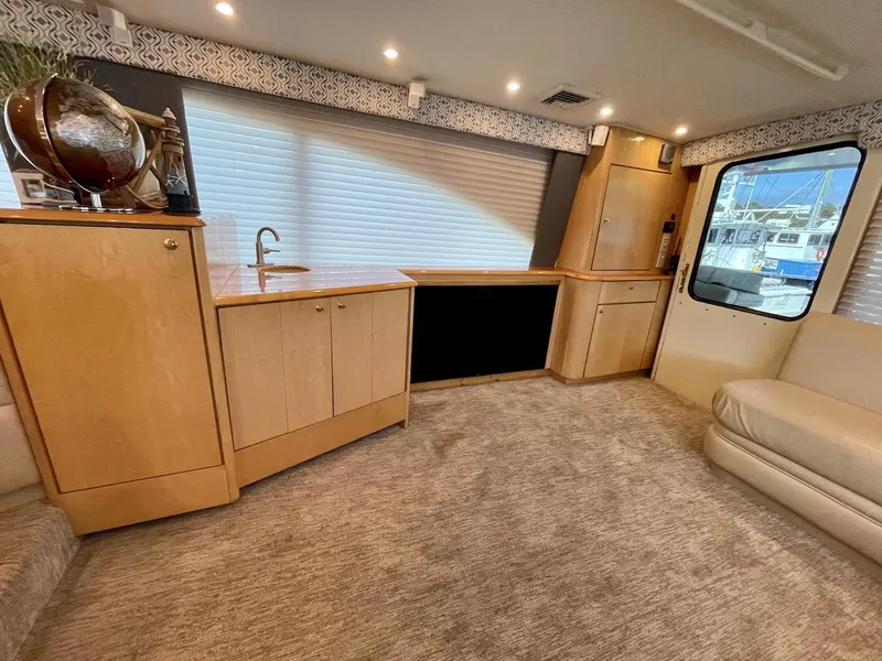 Slide: The Image of Interior of 2003 Ocean Yachts 62 Convertible with modern cabinetry and plush carpeting. - 4