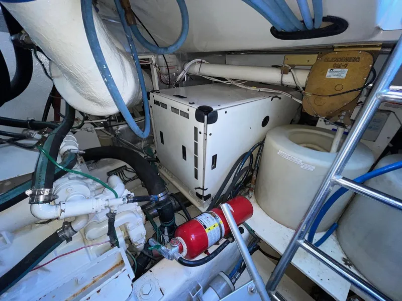 Slide: The Image of Engine room of a 2003 Ocean Yachts 62 Convertible with equipment and fire extinguisher. - 42