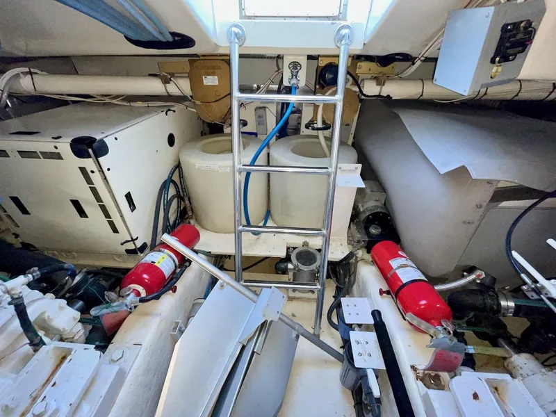 Slide: The Image of Engine room of a 2003 Ocean Yachts 62 Convertible with fire extinguishers and ladder. - 44