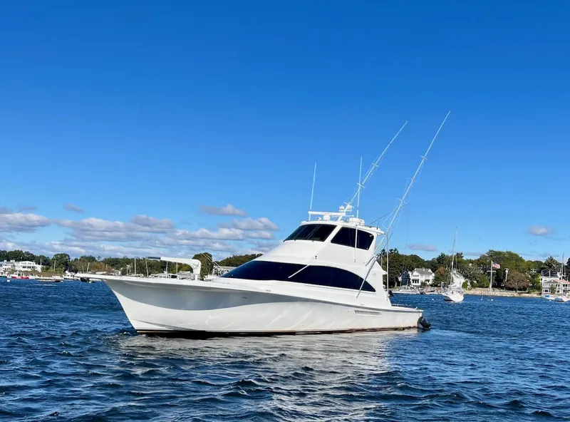 Slide: The Image of 2003 Ocean Yachts 62 Convertible on calm waters with clear blue sky. - 45