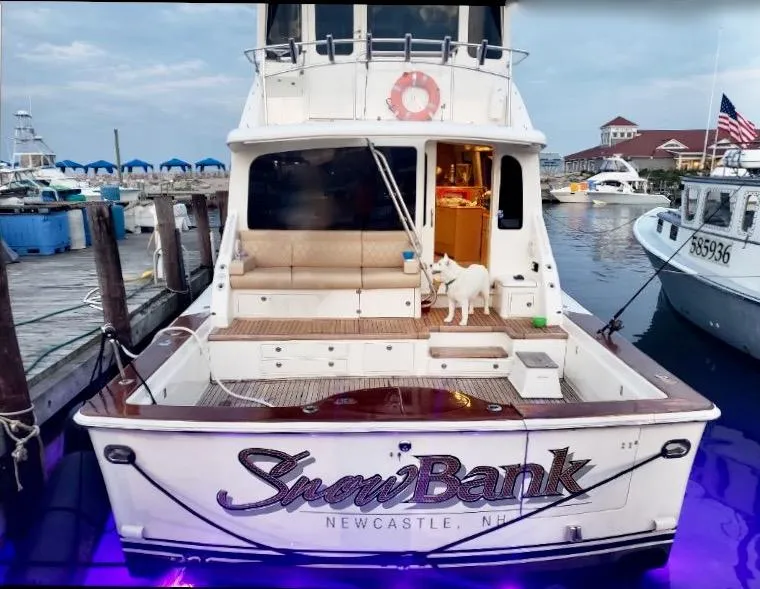 Slide: The Image of 2003 Ocean Yachts 62 Convertible docked, named Snow's Bank, with a dog on the deck in Newcastle, NH. - 48
